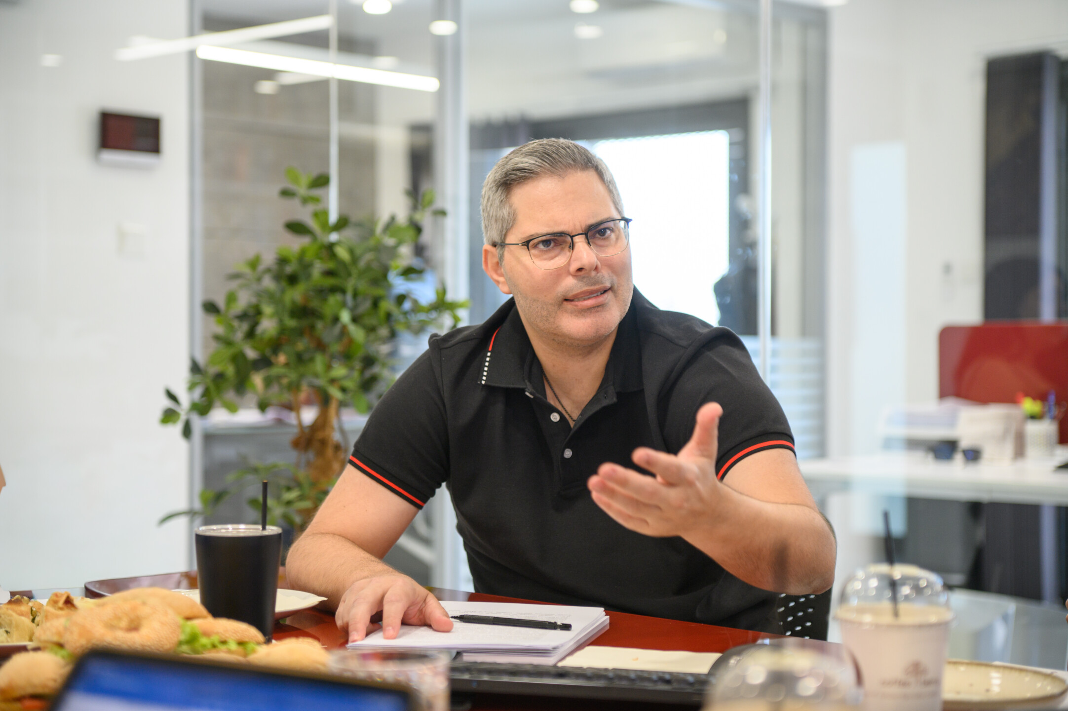 Dr. Panayiotis Agisilaou speaking during an interview about Cyprus competition policy.
